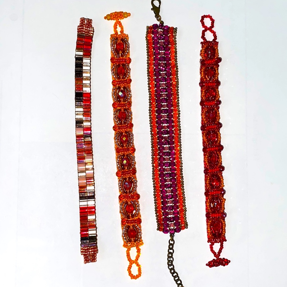 Set of 4 hand beaded bracelets in vivid red orange tones